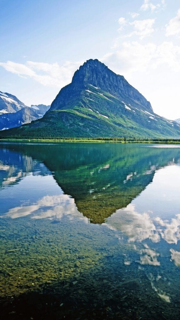 view of lake with reflection of mountain in foreground