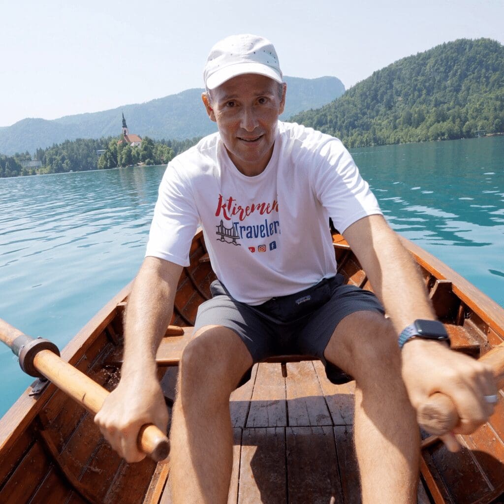 John in a row boat on Lake Bled