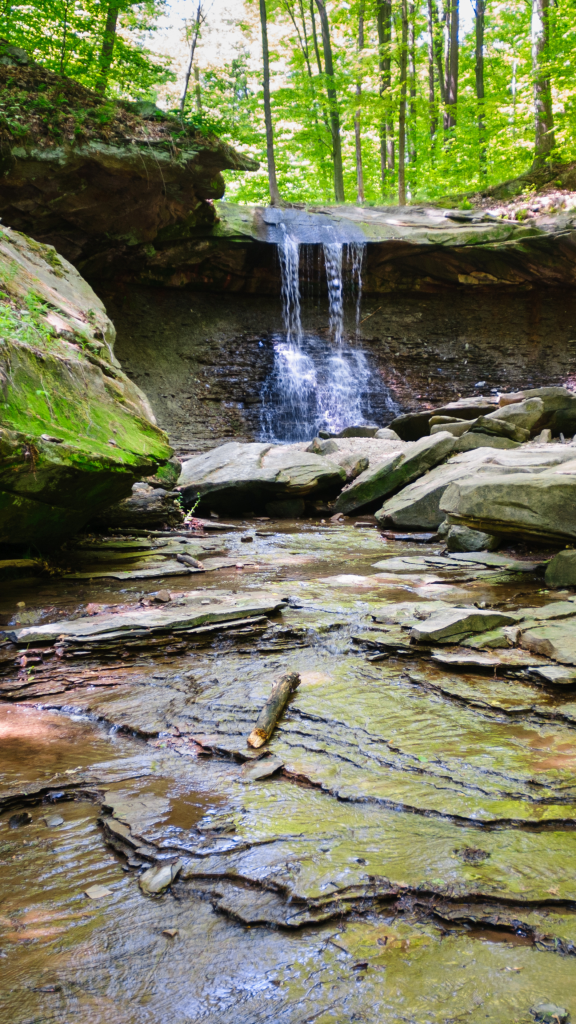 waterfall in park with rock formations around