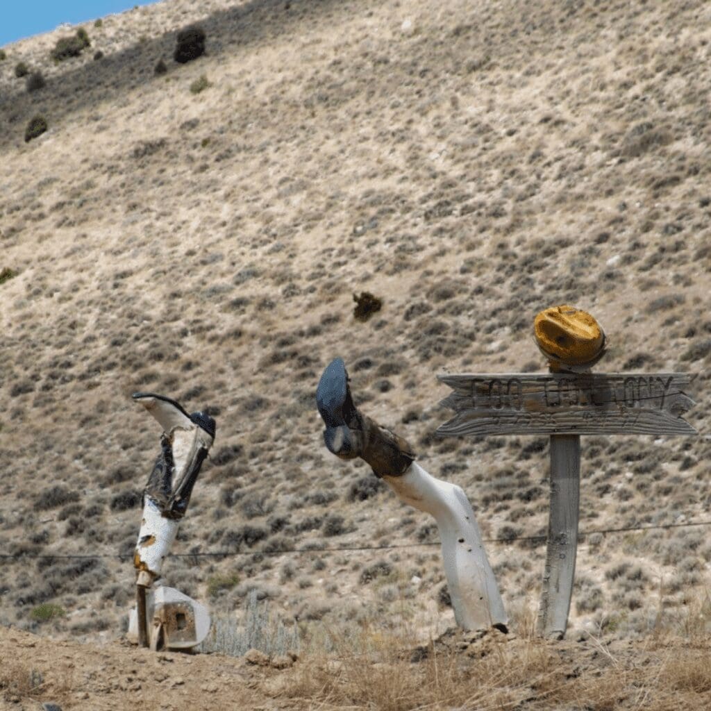 Legs with cowboy boots sticking out of the ground in western US