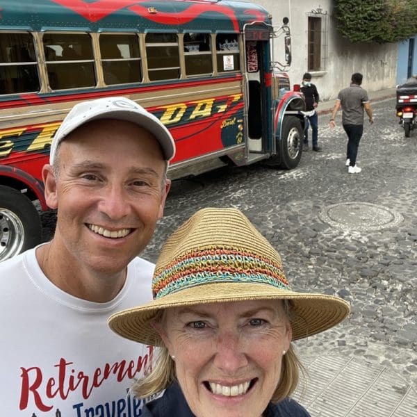 john & Bev in front of chicken bus near Guatemala street food