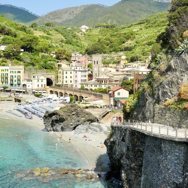 View of the coast with beautiful blue water and rocky cliffs with walkway in Cinque Terre