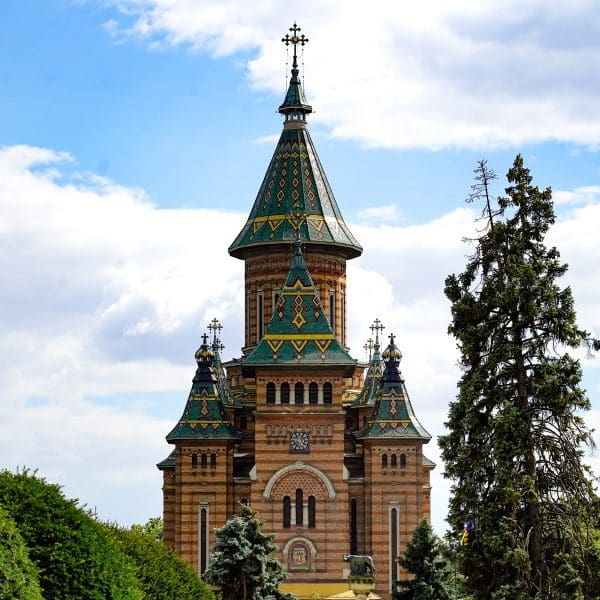 picture of vertical church with green tile roof and round spires