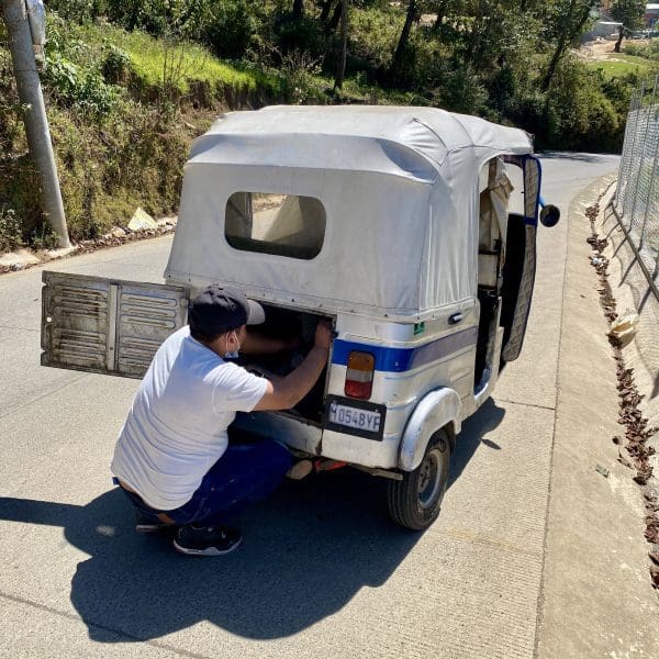 man working on tuktuk
