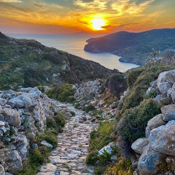 sunset in background, rocky path in foreground on Folegandros Greece