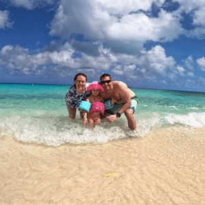 Man and woman with small child on the beach in Bahamas