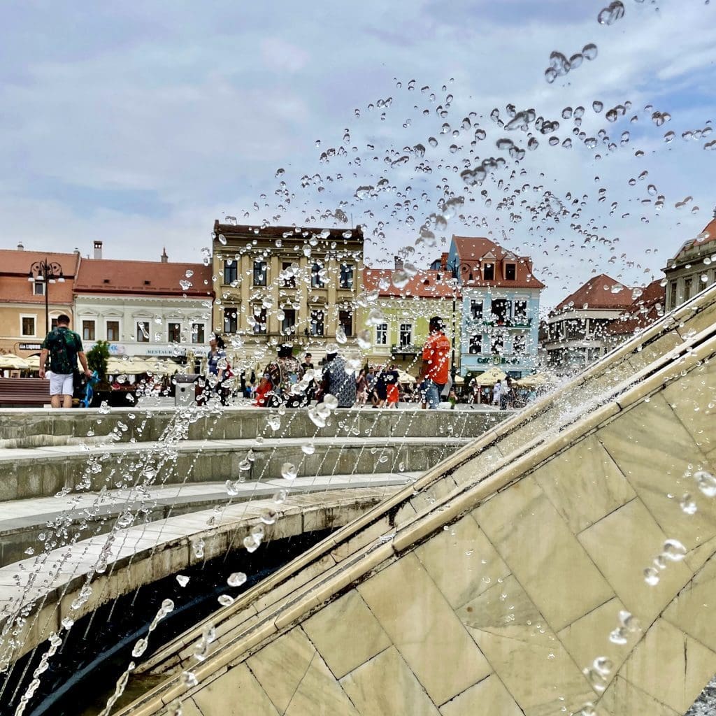 water fountain with droplets with square in background