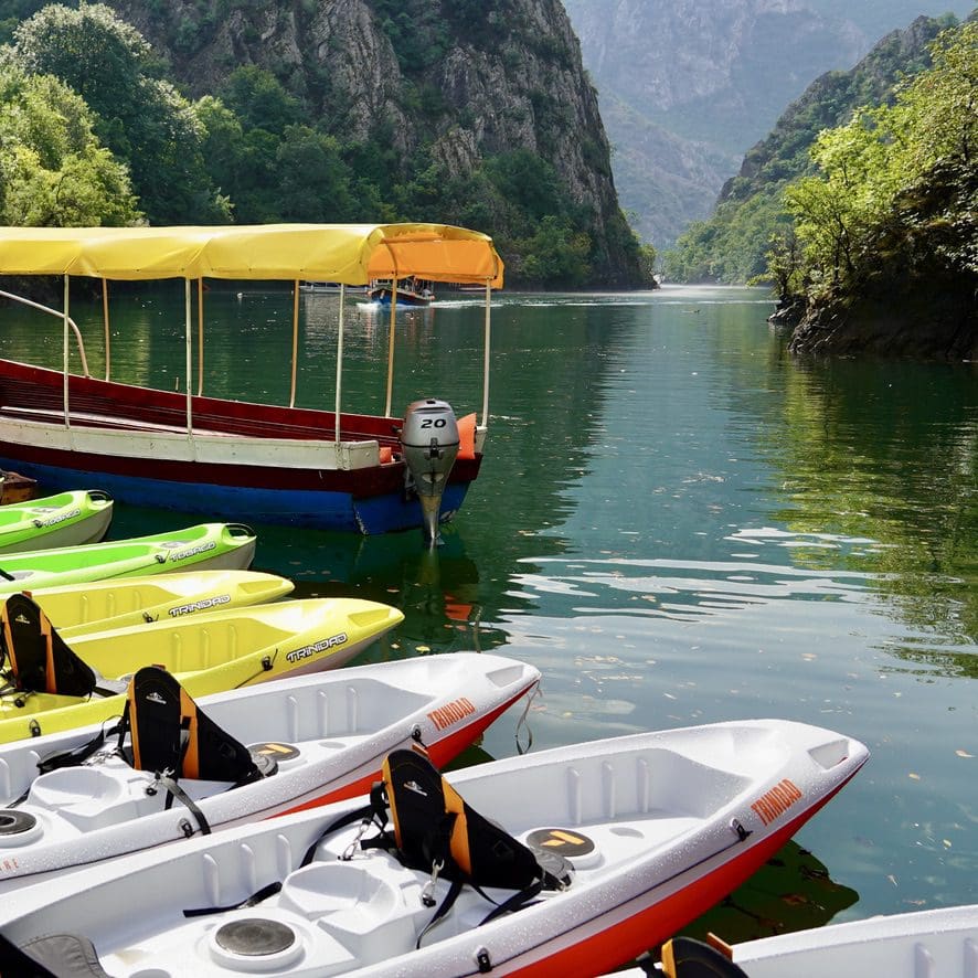 Boats on water with steep canyon walls