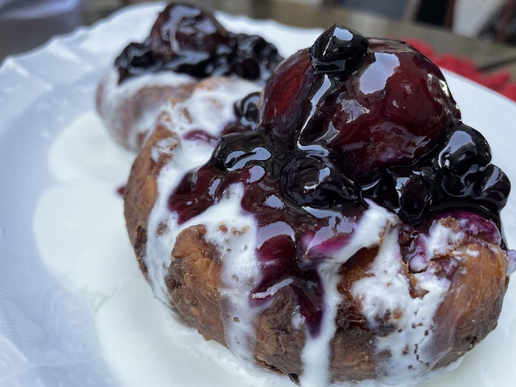 donut type dessert with berry topping