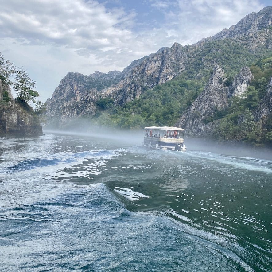 A pontoon boat in a canyon