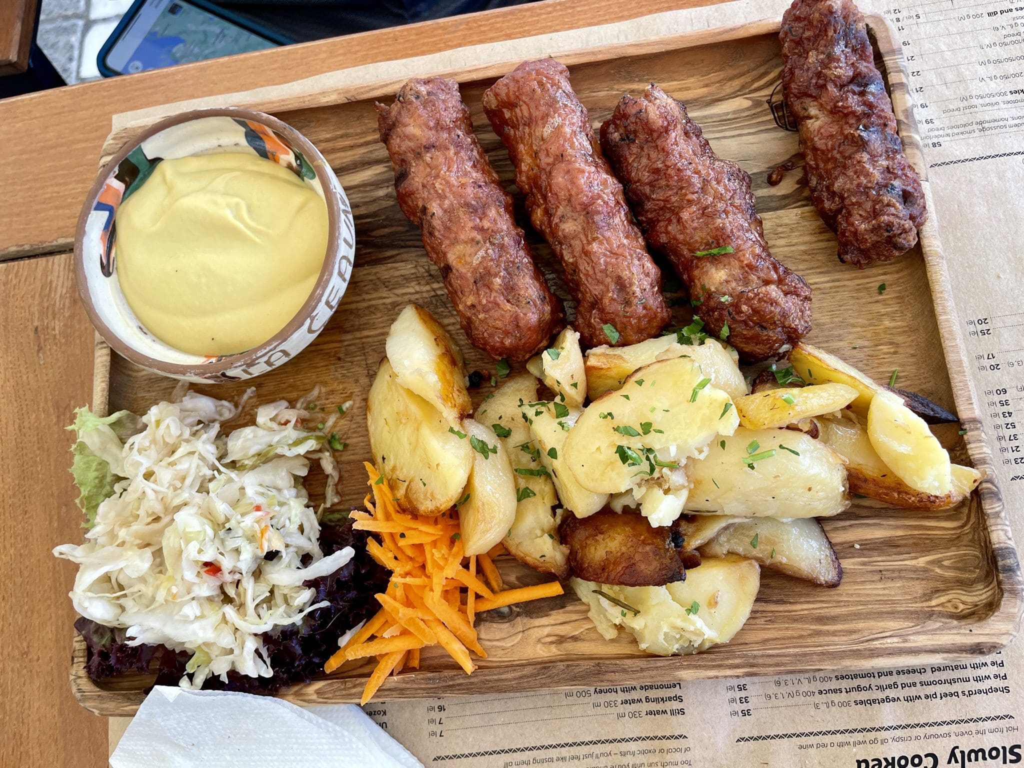 mici and potatoes on cutting board