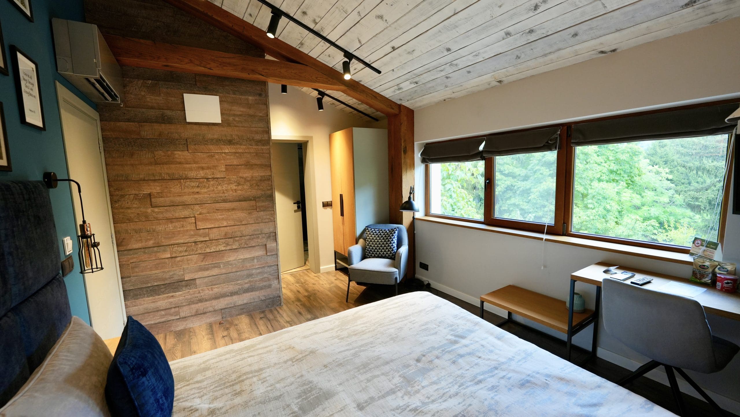 A hotel room with windows looking out to the park
