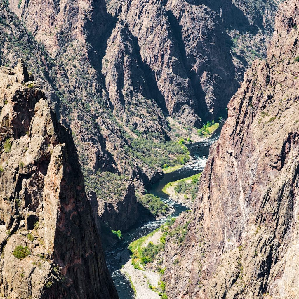 a view of a big canyon with brown and black rock