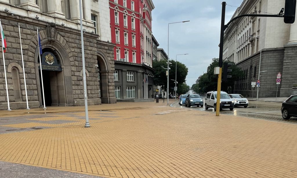 a sidewalk with yellow bricks