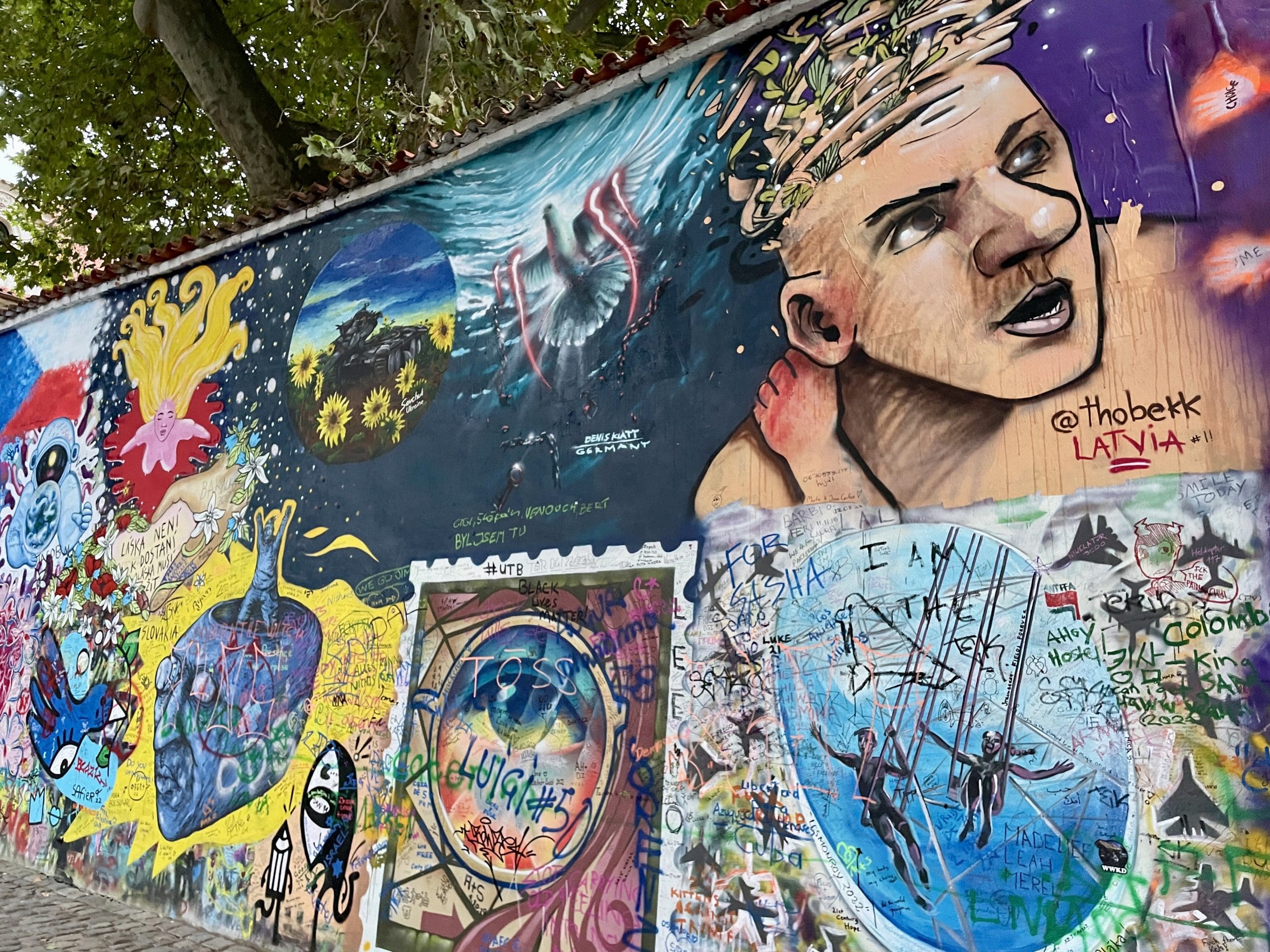 mural of a man, a stamp, and various pictures painted by random artists