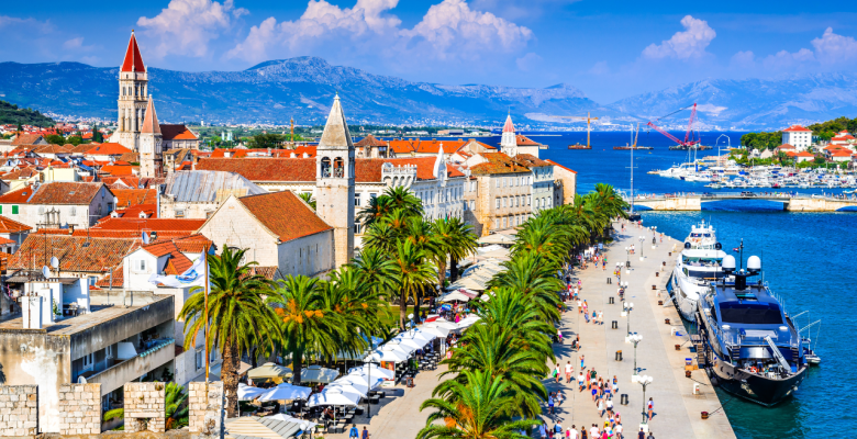 A port with boats in the Croatian city of Split with red tiled roofs