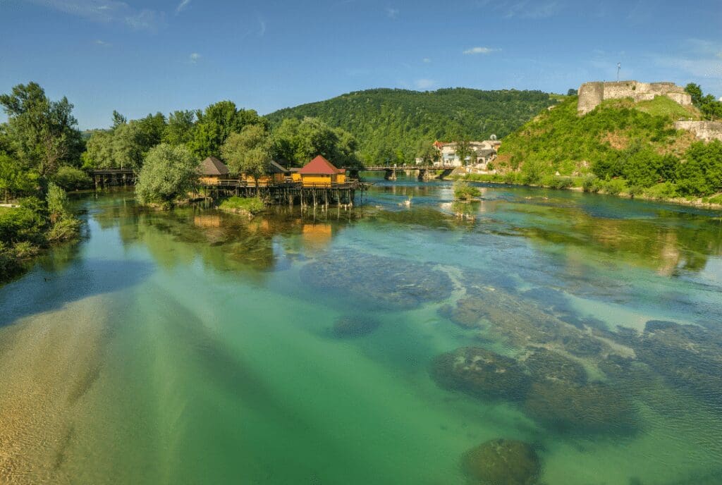 green water with fortress on hillside