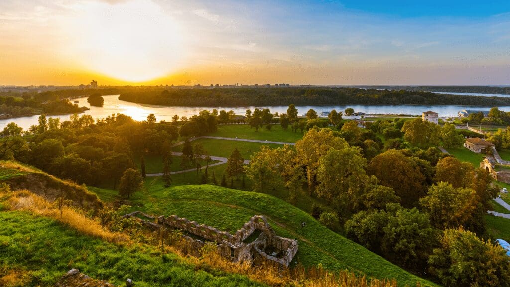 fields and river with sunset