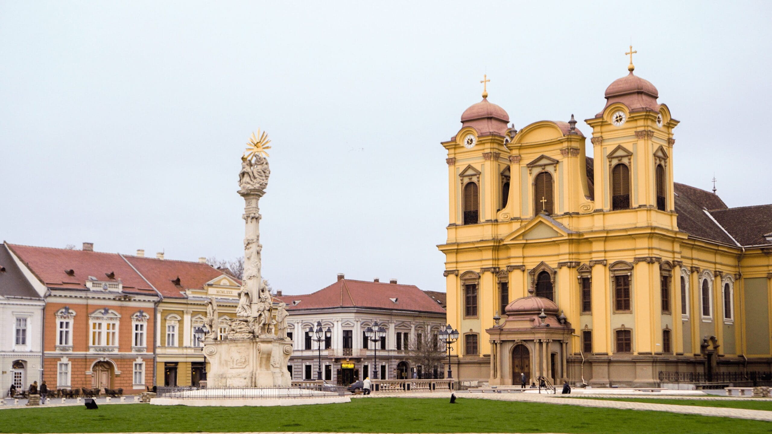 beautiful buildings around a statue in middle of square