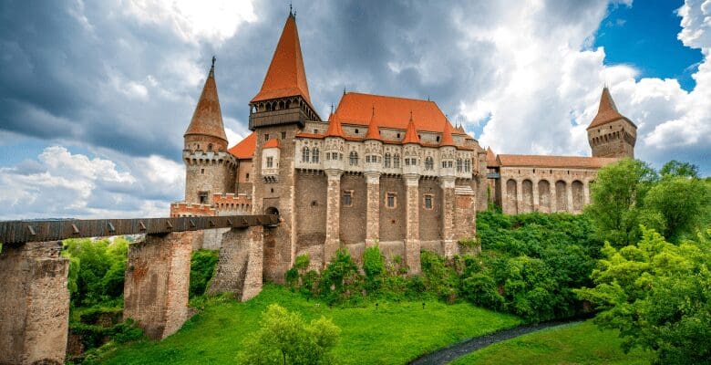 big castle with drawbridge and orange roof