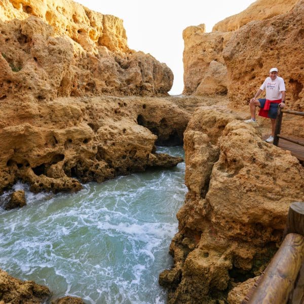 John standing along a narrow inlet on the Algarve coast