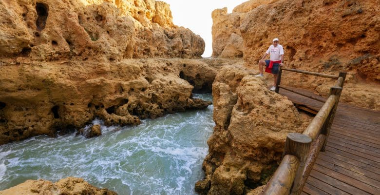 John standing along a narrow inlet on the Algarve coast