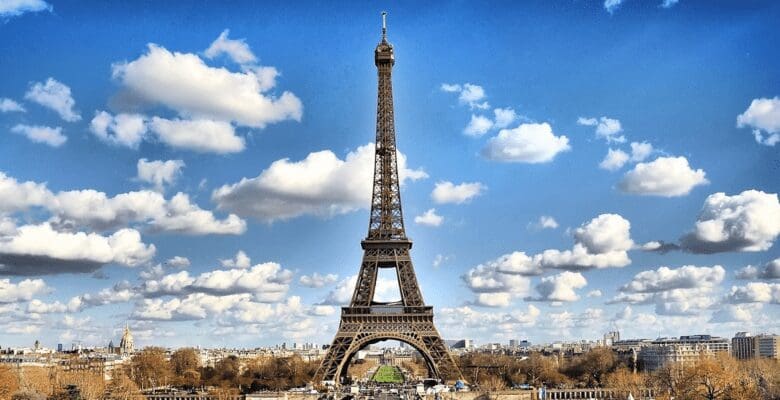 Distant view of the Eiffel Tower in Paris, France with blue skies in the background