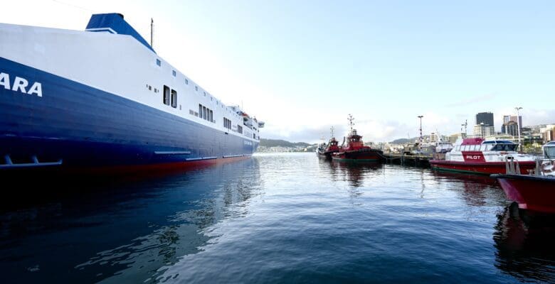 Large ferry boat with small tugs boats in the waterfront area of Wellington New Zealand