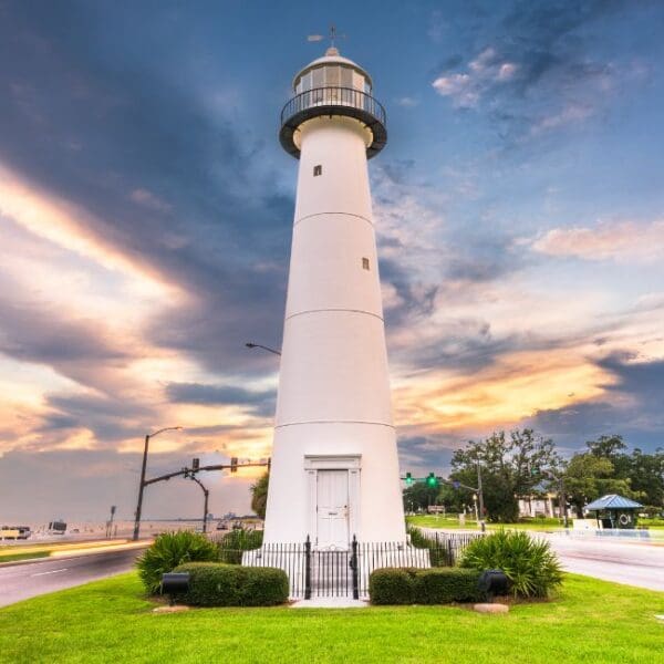 A lighthouse with a beautiful setting sun.