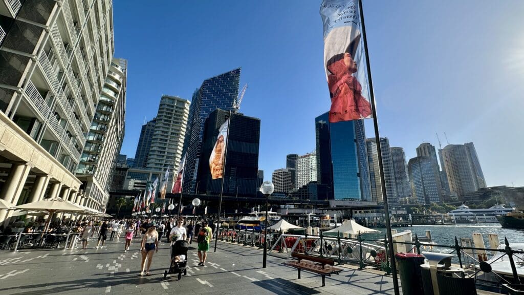 Sydney Australia waterfront with a large pedestrian walkway and many large buildings