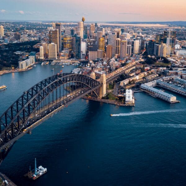 An aerial view of Sydney, Australia, and the Sydney Opera House surrounded by the Pacific Ocean.