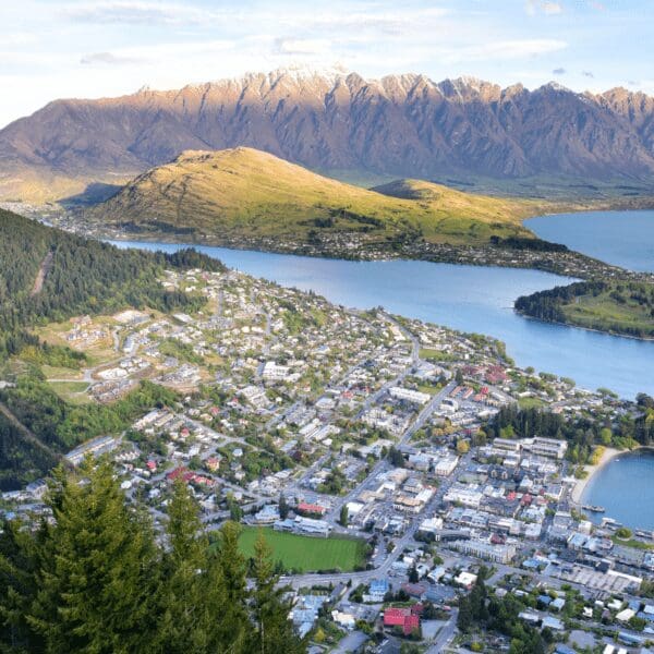 The city of Queenstown, New Zealand surrounded by water and mountainous terrain.