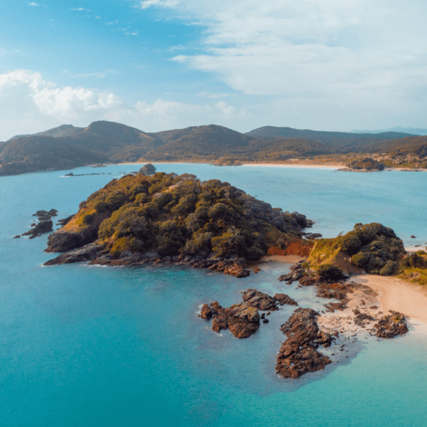 View of North Island coastline with sandy beaches and blue ocean water.
