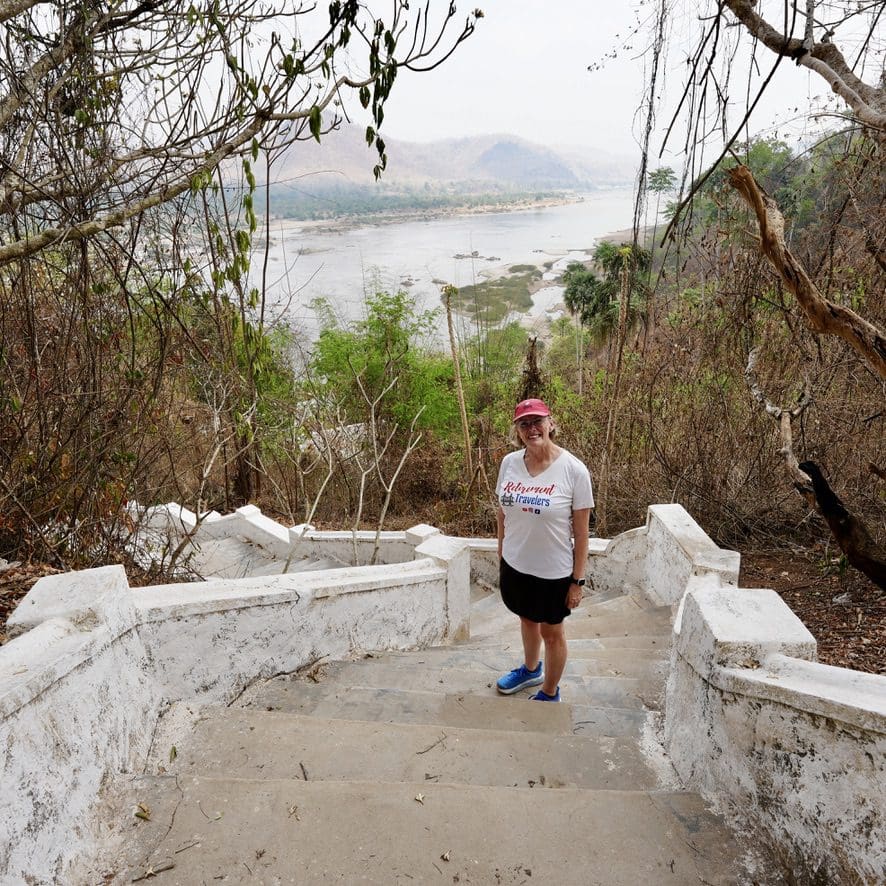 woman standing on stairs with river in background