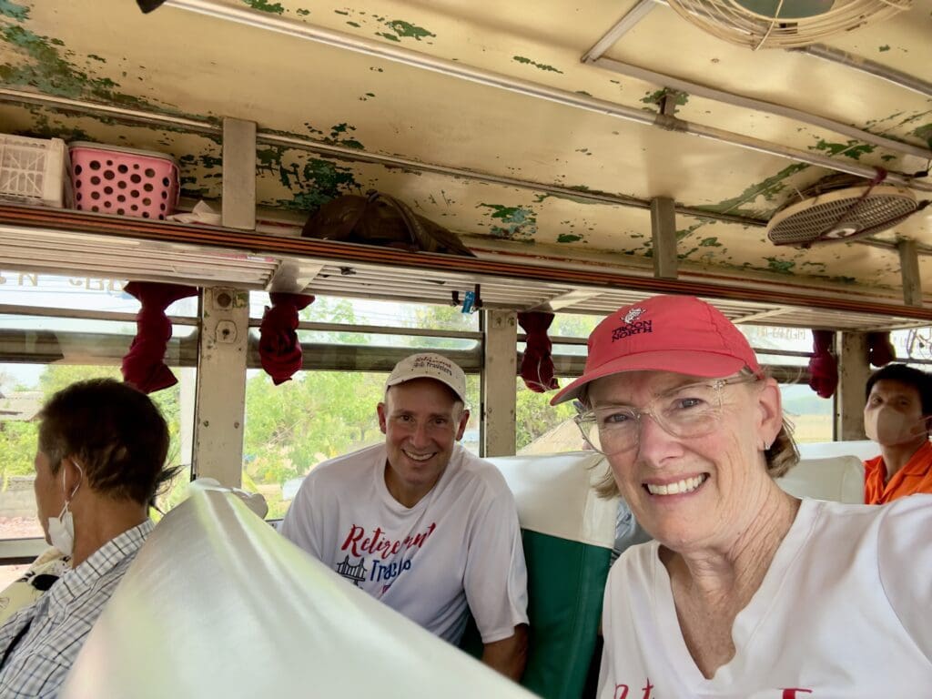 people riding on an old bus in Thailand