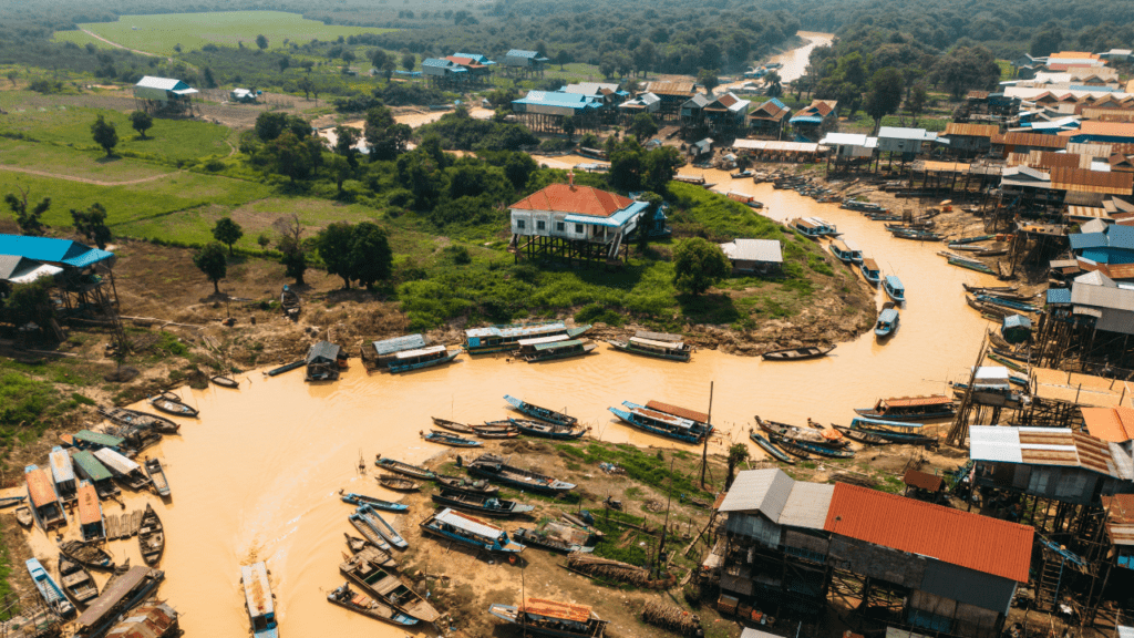 snake shaped river with boats surrounded by housing