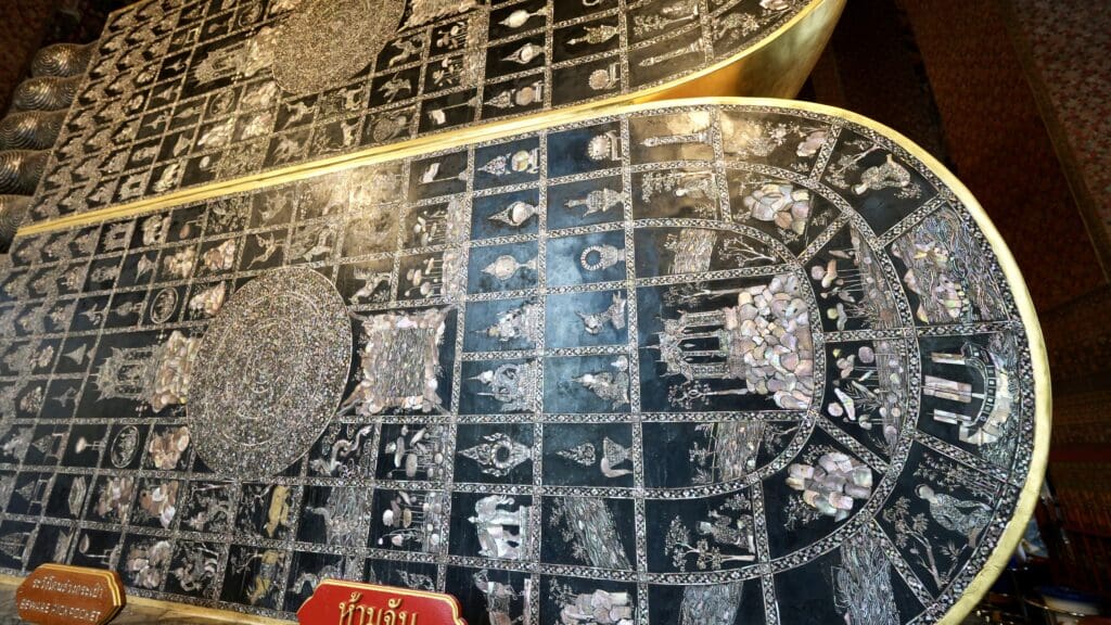 ancient writing on a gold plaque at the reclining Buddha in Bangkok
