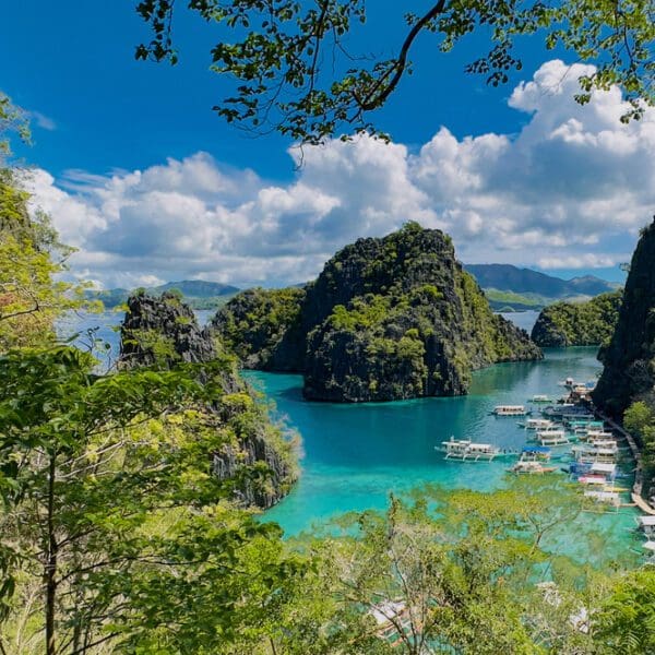 View of beautiful turquoise water with steep green mountains surrounding