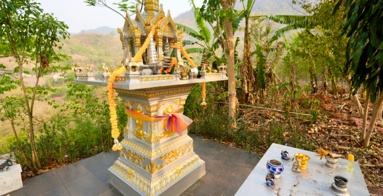 An altar with flowers and items in Pakbeng