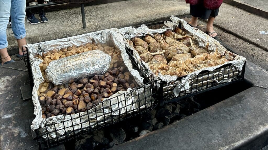 chicken and potatoes in large serving containers wrapped in aluminum foil
