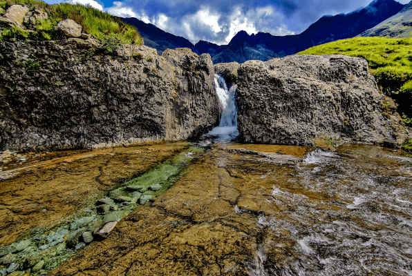 small, narrow waterfall in a Scottish fairy pool