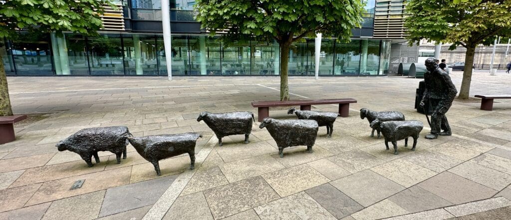 Sheep and farmer statues in a park in Belfast