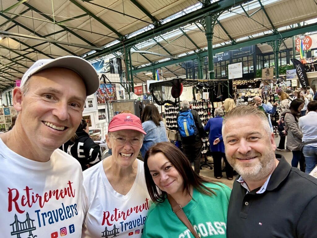John and Bev Retirement Travelers with 2 other people in Belfast market