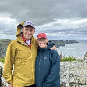 man and woman standing at the cliffs of Moher in Ireland