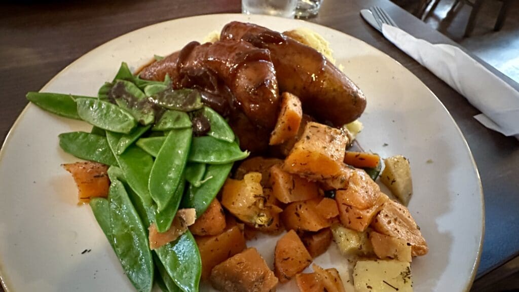 Irish meal on a plate with potatoes, peas and chicken