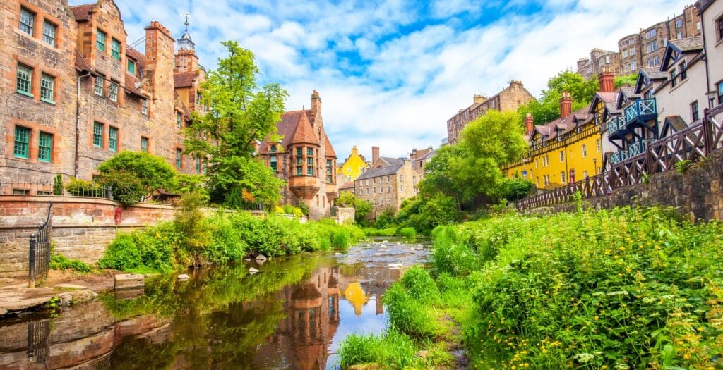 view of buildings in Edinburgh, Scotland beside flowing river