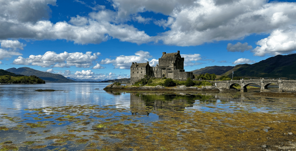 view of Eilean Donan castle surrounded by a lake in Scotland