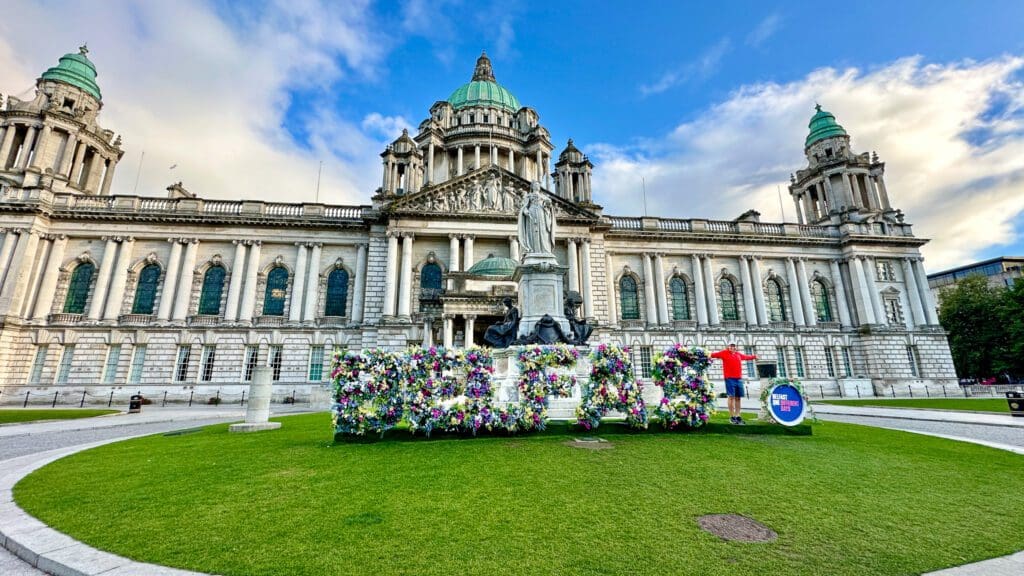 man standing as the T in a Belfast Sign at City Hall