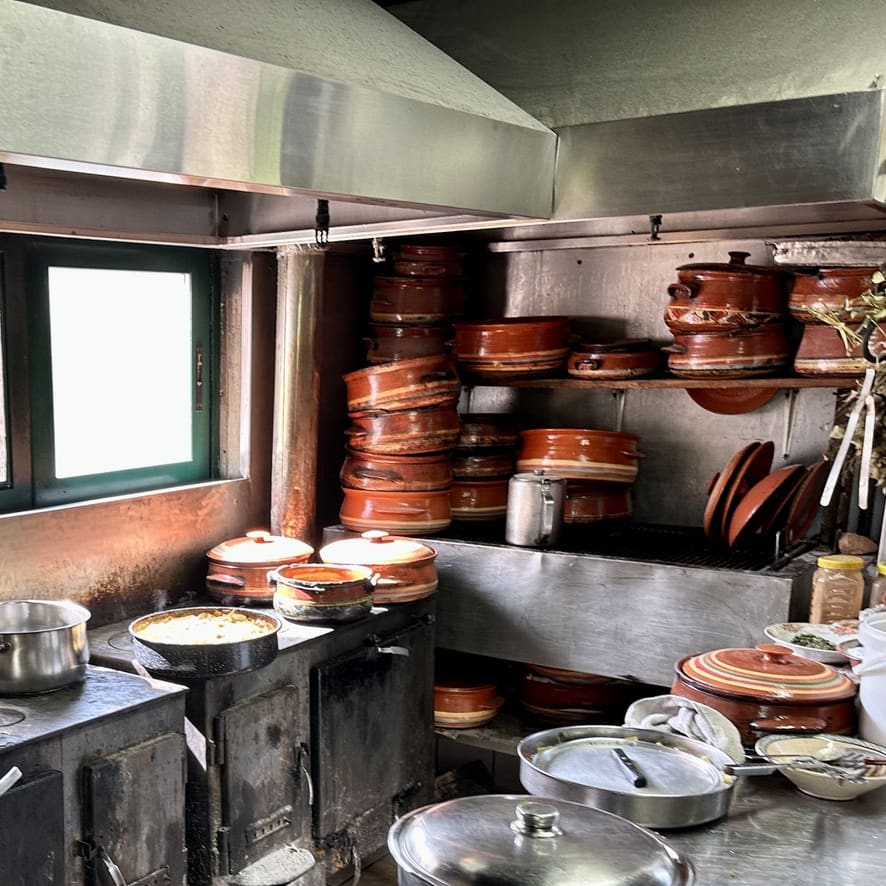 A view of authentic clay pots and pans on stoves that are fired with wood.