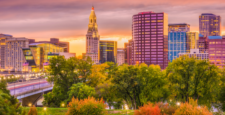 buildings at sunset in a city with trees in the foreground in Hartford Connecticut